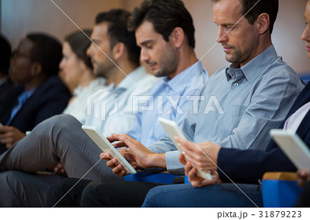 Business executives participating in a business meeting using digital tablet Business executives participating in a business meeting using digital tablet 31879223