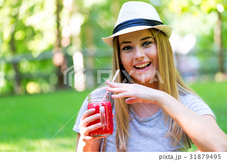 Young woman drinking smoothie Young woman drinking smoothie 31879495