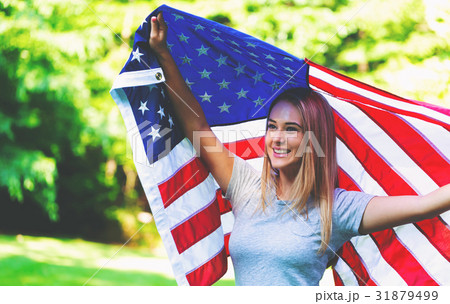 Girl with an American flag on the fourth of July 31879499