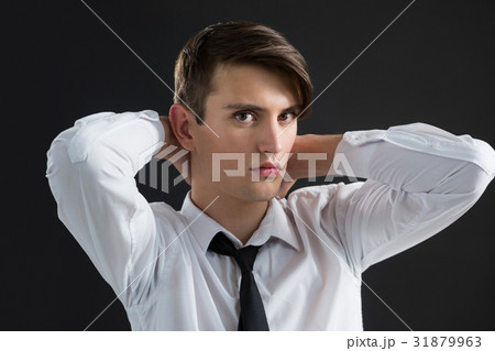 Androgynous man with hands on his neck 31879963