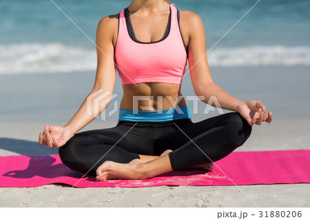 Woman meditating in lotus position 31880206