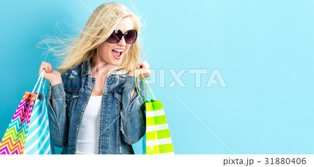 Happy young woman holding shopping bags Happy young woman holding shopping bags 31880406