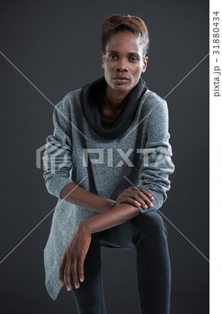 Androgynous man posing against grey background 31880434