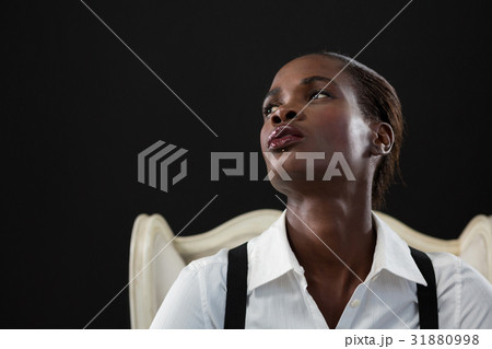 Androgynous man sitting on a chair Androgynous man sitting on a chair 31880998