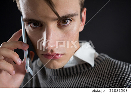 Angry androgynous man talking on mobile phone 31881593