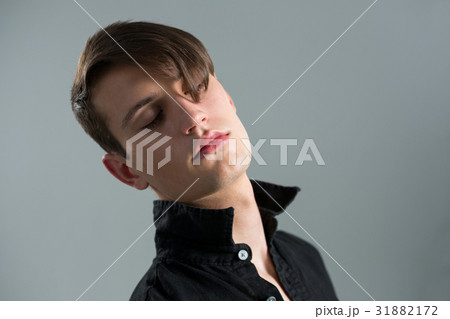 Androgynous man posing with eyes closed Androgynous man posing with eyes closed 31882172