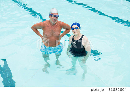 Senior couple standing in swimming pool 31882804