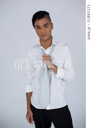 Portrait of transgender woman holding tie 31883121