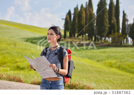 Woman  holding map with backpack in the road and Tuscany backgro 31887362
