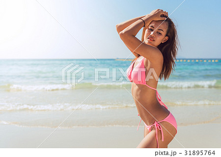 Sexy bikini body woman sun tanning relaxing beach Sexy bikini body woman sun tanning relaxing beach 31895764