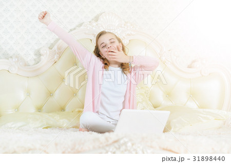 Girl sitting on couch with laptop 31898440