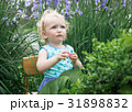 Little girl in the garden. 31898832