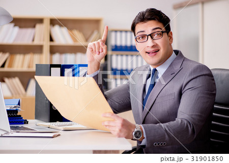Businessman receiving letter envelope in office 31901850