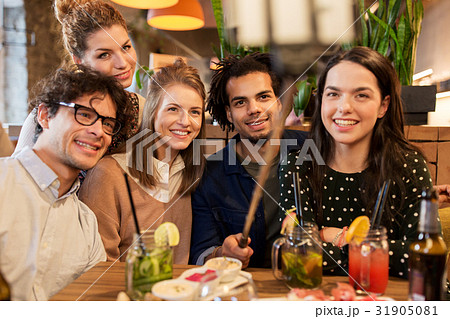 friends taking selfie by smartphone at bar or cafe friends taking selfie by smartphone at bar or cafe 31905081
