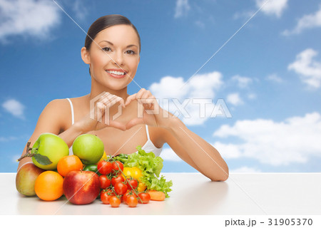 woman with fruits and vegetables showing heart woman with fruits and vegetables showing heart 31905370
