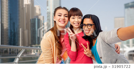 international happy women taking selfie in city 31905722