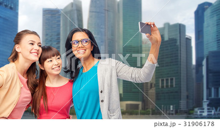international happy women taking selfie in city 31906178