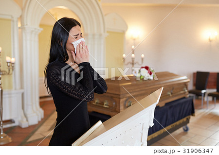 woman crying near coffin at funeral in church woman crying near coffin at funeral in church 31906347