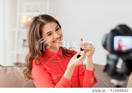 woman with lipstick and camera recording video woman with lipstick and camera recording video 31906602