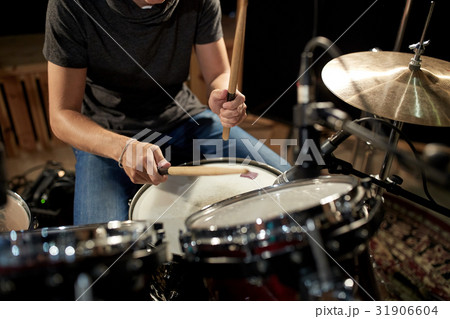 male musician playing drums and cymbals at concert 31906604