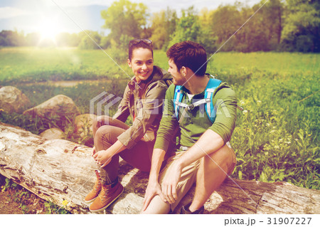 smiling couple with backpacks in nature 31907227
