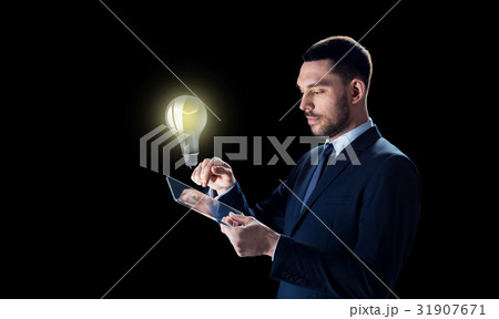 businessman with tablet pc and lightbulb 31907671