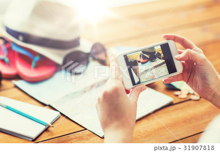 close up of woman with smartphone and travel stuff 31907818
