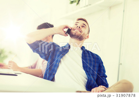 happy creative man calling on cellphone at office happy creative man calling on cellphone at office 31907878
