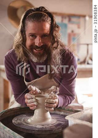 Male potter making pot Male potter making pot 31908384
