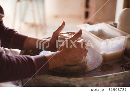 Male potter making pot Male potter making pot 31908721