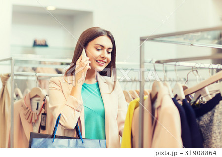 happy young woman choosing clothes in mall 31908864