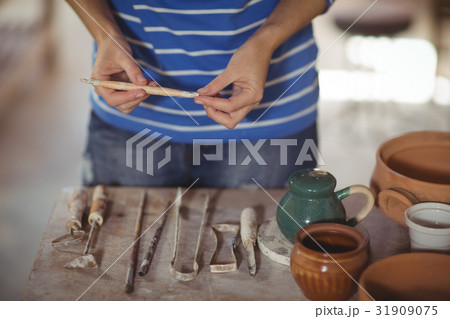 Mid section of potter holding work tool 31909075