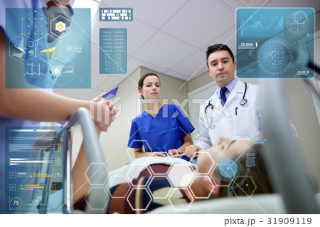 medics and patient on hospital gurney at emergency 31909119