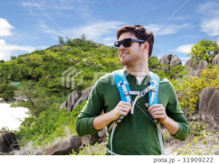 happy man with backpack traveling around island happy man with backpack traveling around island 31909222