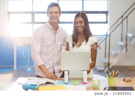 Business people standing with a laptop 31909362