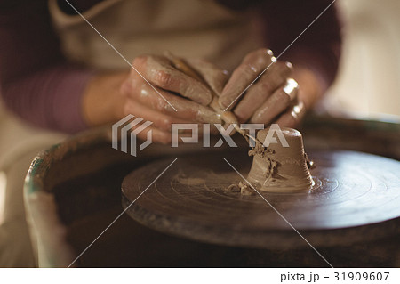 Close-up of potter working on bowl Close-up of potter working on bowl 31909607