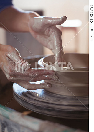 Close-up of female potter making pot 31909759