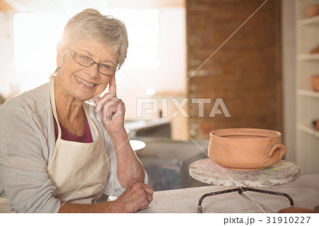 Female potter sitting at table 31910227