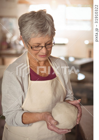 Close-up of female potter molding clay Close-up of female potter molding clay 31910322