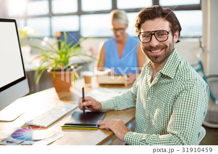 Graphic designer using graphics tablet 31910459