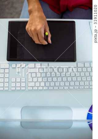 Graphic designer using graphics tablet Graphic designer using graphics tablet 31911020