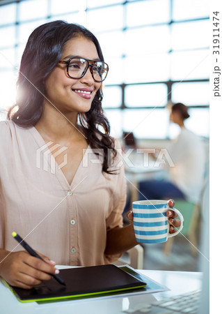 Businesswoman using graphic tablet Businesswoman using graphic tablet 31911474