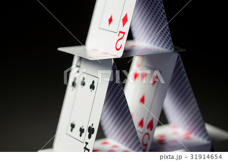 close up of house of playing cards over black 31914654