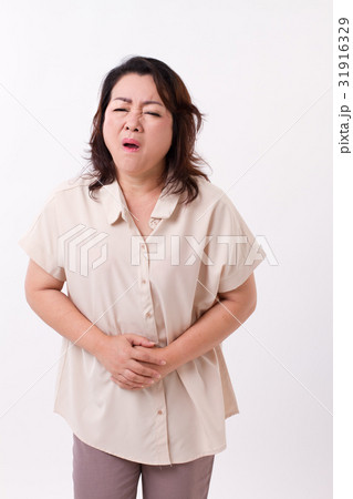 middle aged woman suffering from stomach ache 31916329