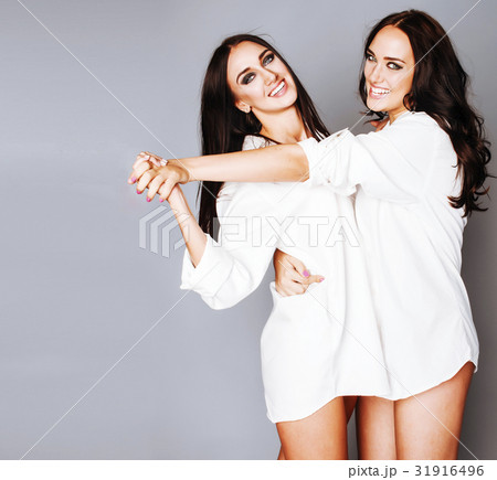 two sisters twins girl posing, making photo selfie two sisters twins girl posing, making photo selfie 31916496
