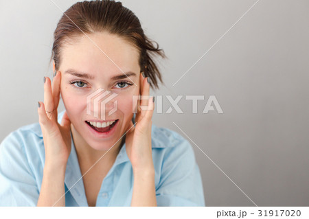 Young woman touching cheeks self-massage 31917020