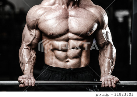Handsome power athletic man on diet training pumping up muscles Handsome power athletic man on diet training pumping up muscles 31923303