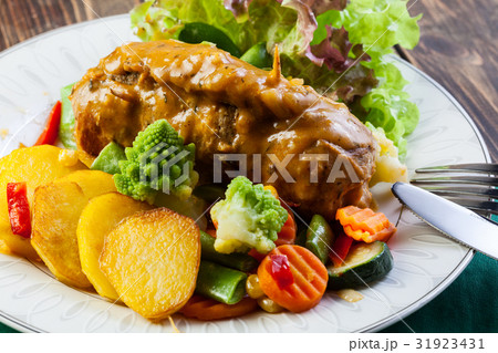 Pork rolls with prepared potatoes and vegetables Pork rolls with prepared potatoes and vegetables 31923431