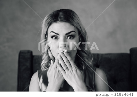 Surprised woman with hand over mouth Surprised woman with hand over mouth 31924641