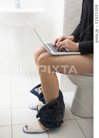 young man in toilet using laptop young man in toilet using laptop 31925109
